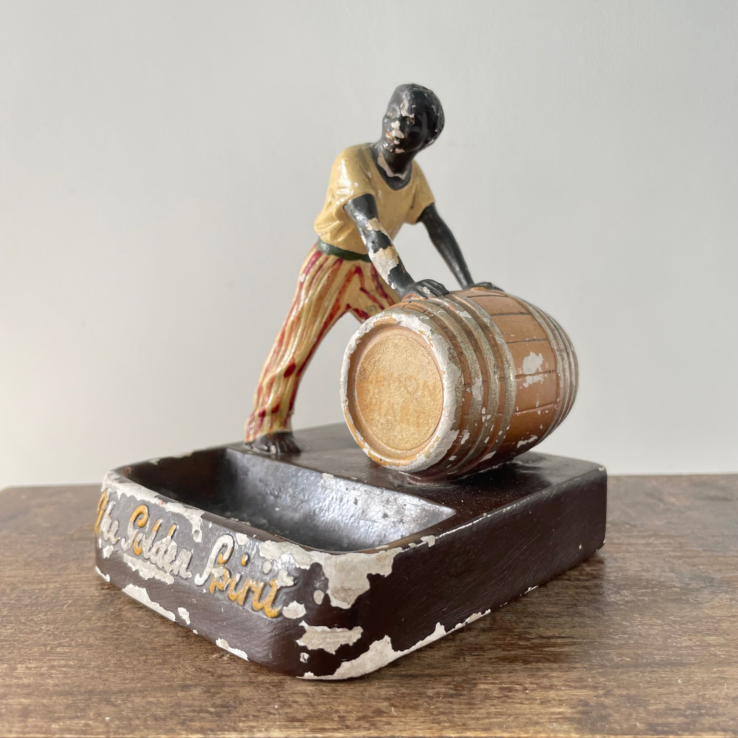 Antique “The Golden Spirit” Lemon Hart Rum Advertising Ceramic Figure Ashtray c.1920s–30s (Repaired)