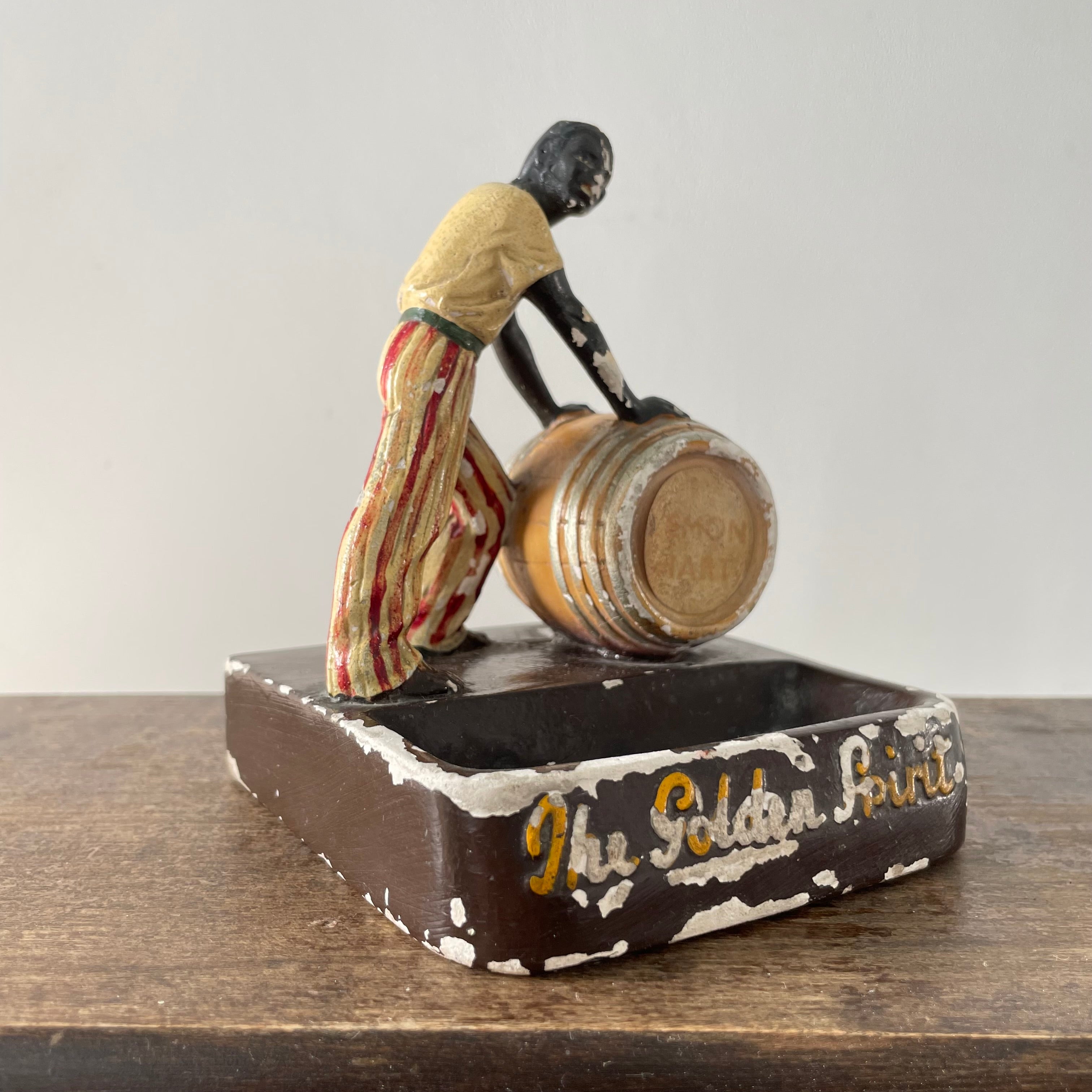 Antique “The Golden Spirit” Lemon Hart Rum Advertising Ceramic Figure Ashtray c.1920s–30s (Repaired)