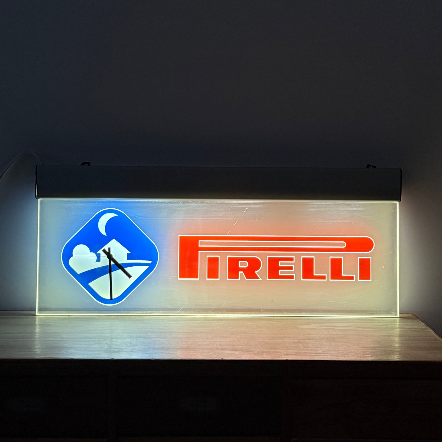 Illuminated Pirelli garage advertising lightbox sign with clock