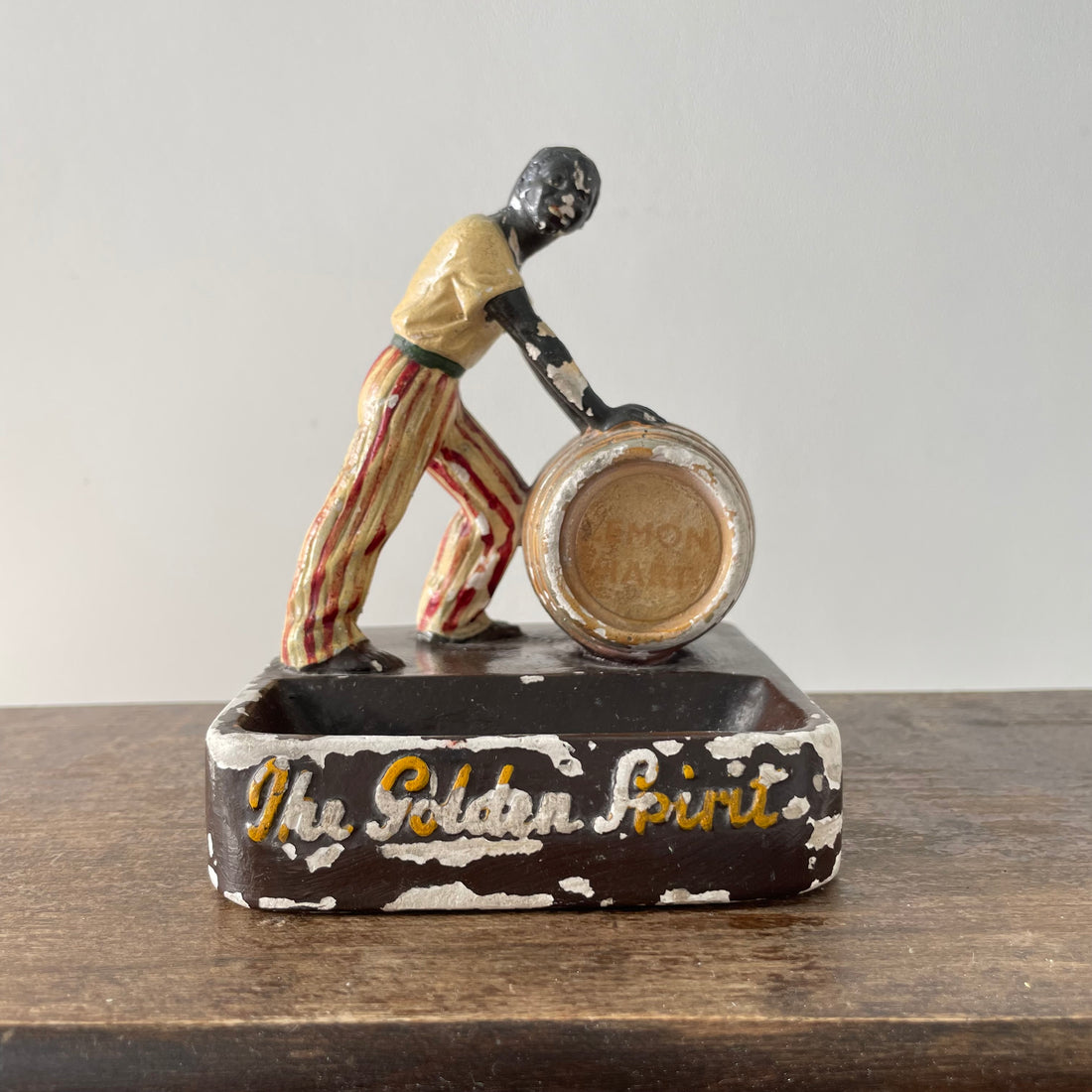 Antique “The Golden Spirit” Lemon Hart Rum Advertising Ceramic Figure Ashtray c.1920s–30s (Repaired)