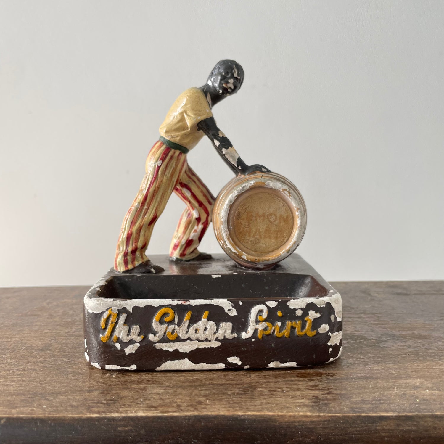 Antique “The Golden Spirit” Lemon Hart Rum Advertising Ceramic Figure Ashtray c.1920s–30s (Repaired)