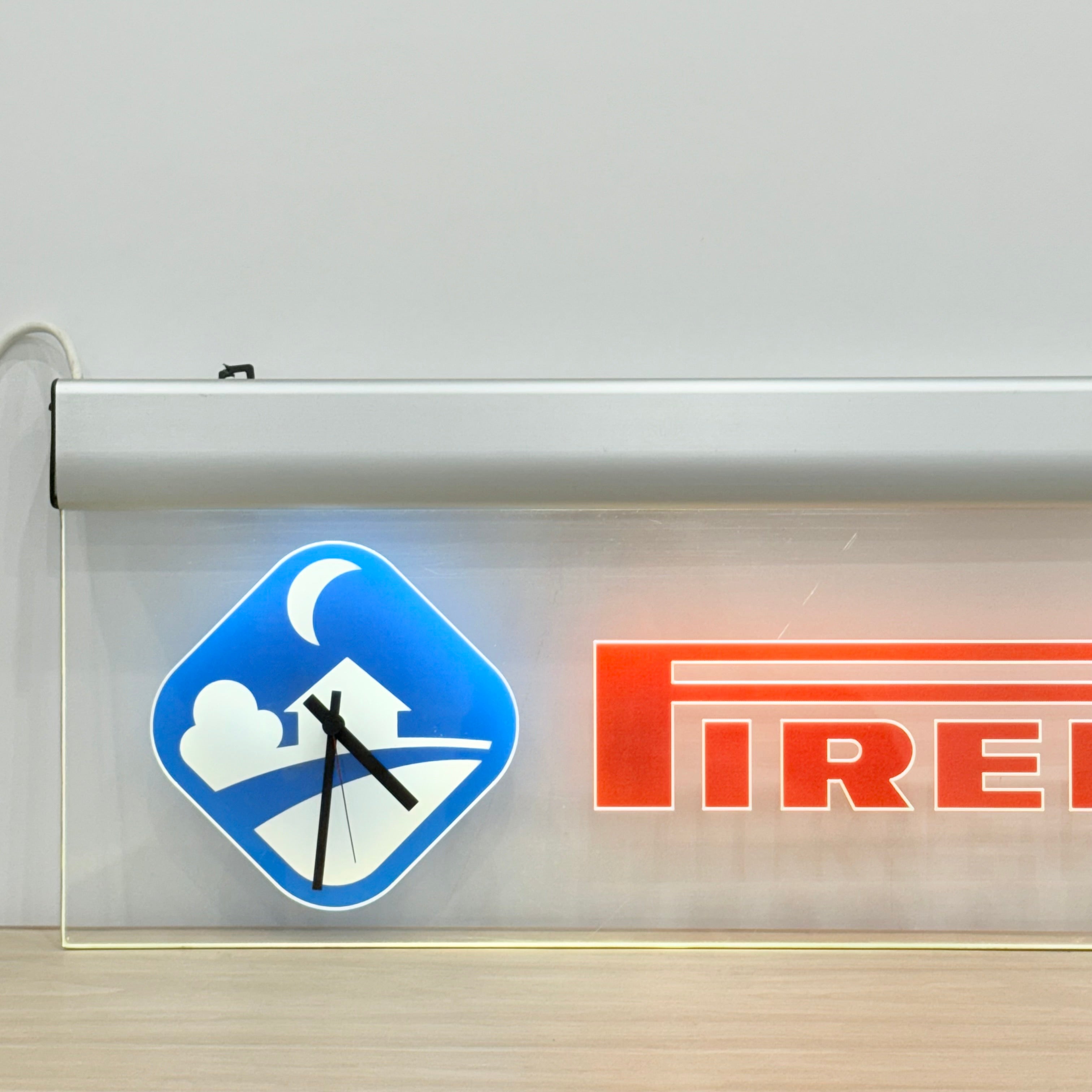 Illuminated Pirelli garage advertising lightbox sign with clock